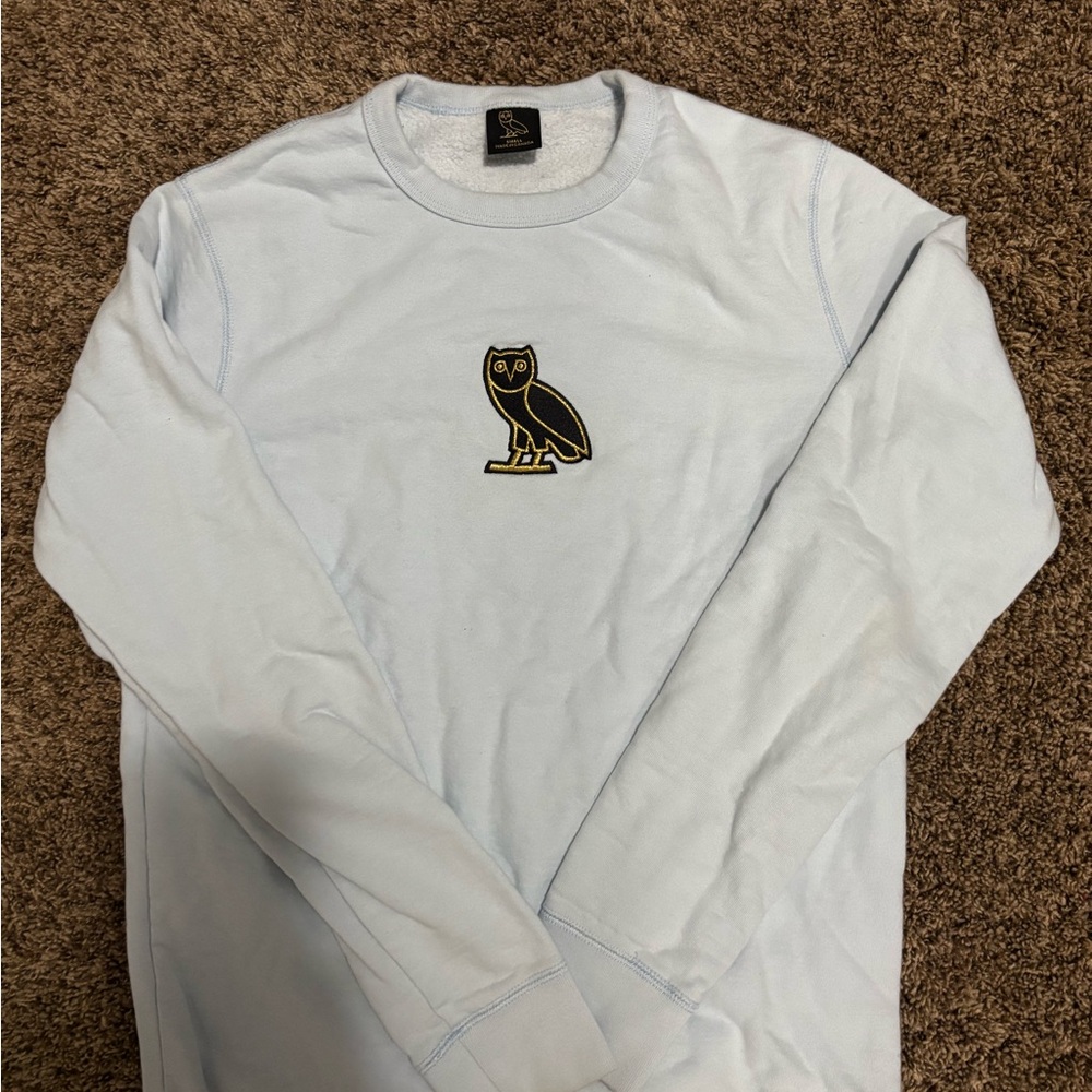 OVO Drake Light Blue Sweatshirt with Black and Gold Owl Patch